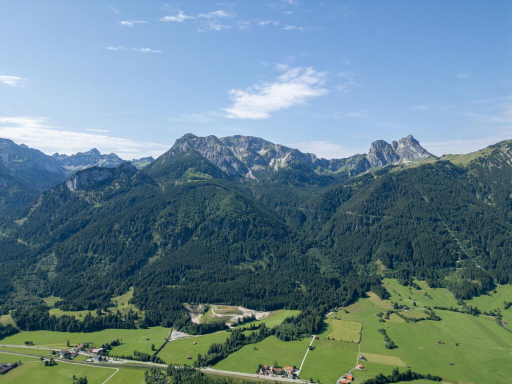 A stunning aerial view of the lush green landscapes and majestic mountains in Bavaria, Germany.